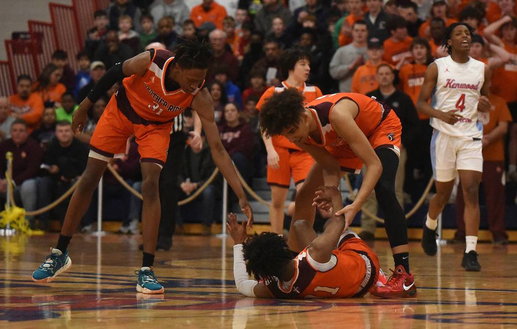 Brother Rice's Ahmad Henderson (11) gets checked on by Khalil Ross (31) and Zavier Fitch (13) after he went down with an injury during the Class 4A St. Rita Sectional championship game in Chicago on Friday, March 3, 2023.