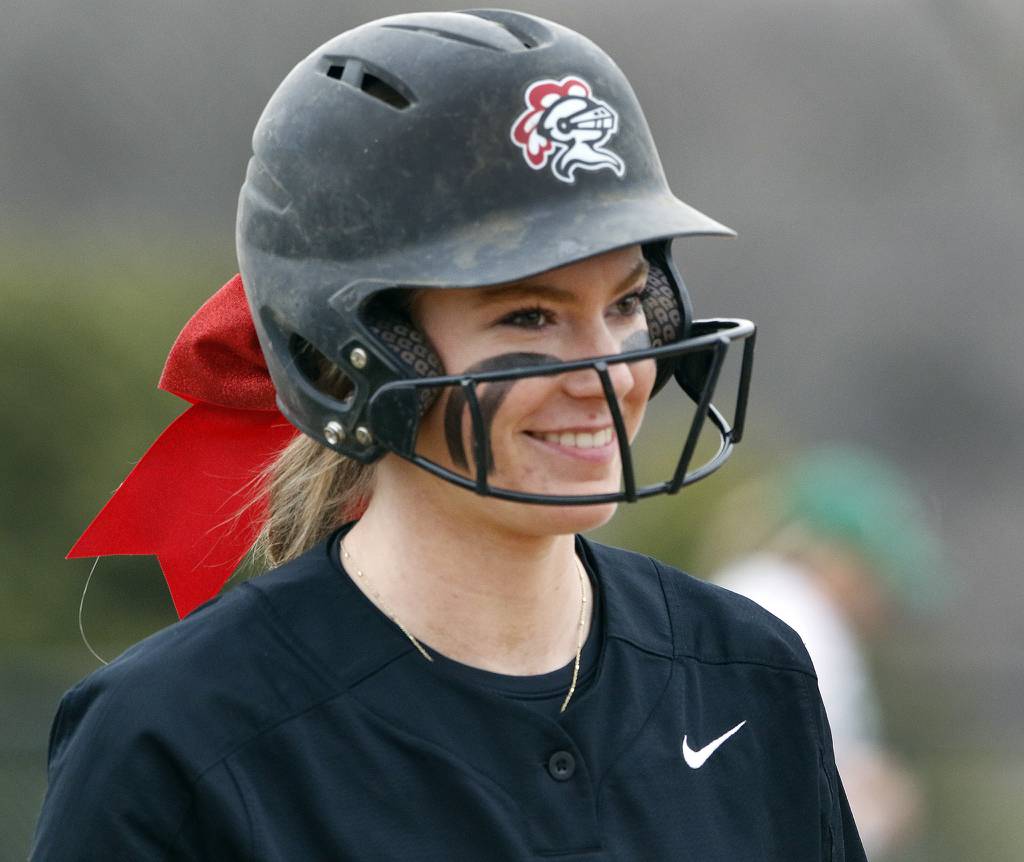 Lincoln-Way Central pitcher Bella Dimitrijevic is all smiles as she enters the batter's box against Providence during a nonconference game in New Lenox on Tuesday, March 21, 2023.
