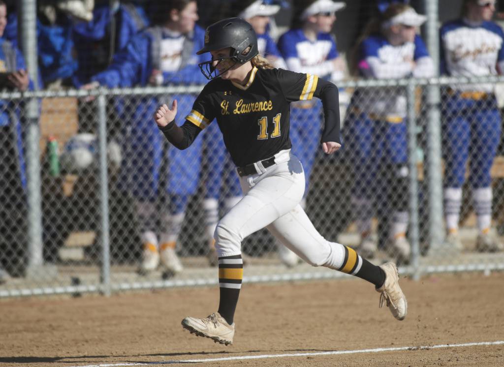 St. Laurence’s Emma Lotus (11) scores a run against Sandburg during a nonconference game in Orland Park on Monday, March 27, 2023.