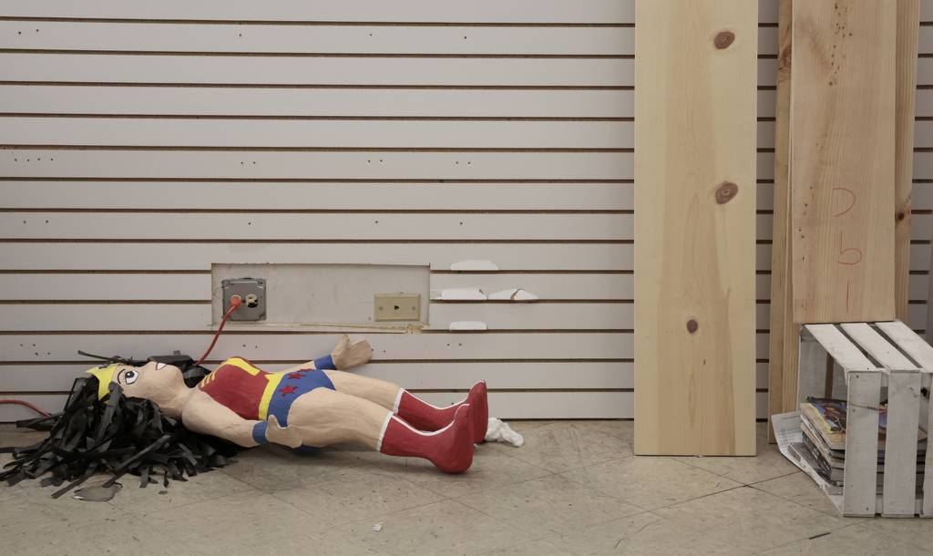 A Wonder Woman piñata is seen on the ground as vendors and workers move out merchandise from the Discount Mall in Chicago's Little Village neighborhood on March 27, 2023. 