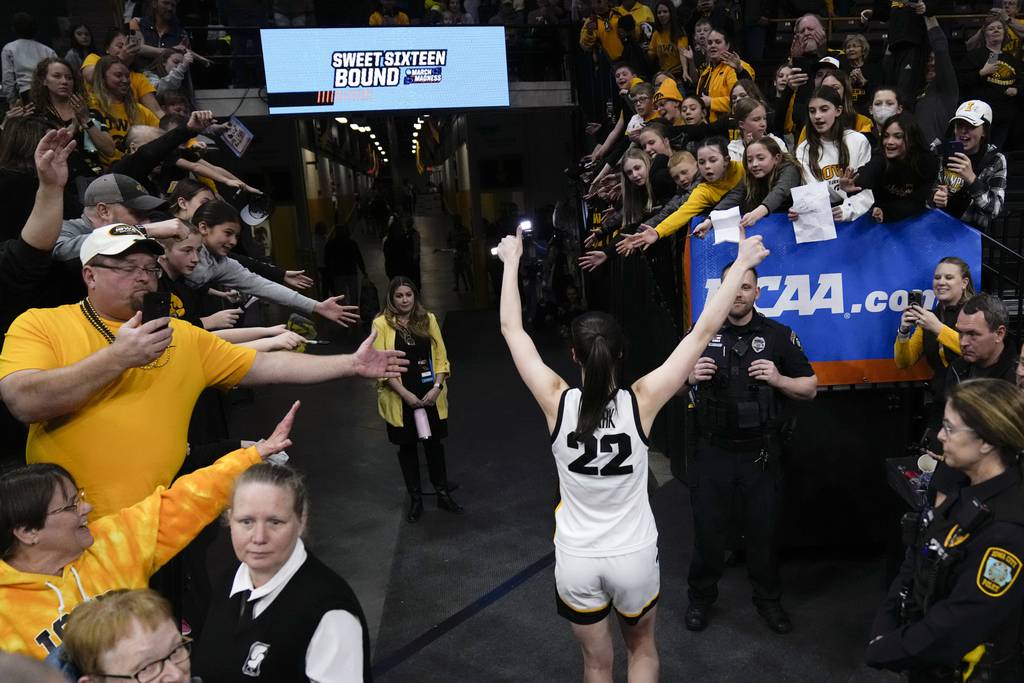 Iowa guard Caitlin Clark celebrates with fans after a second-round college game against Georgia on March 19, 2023.