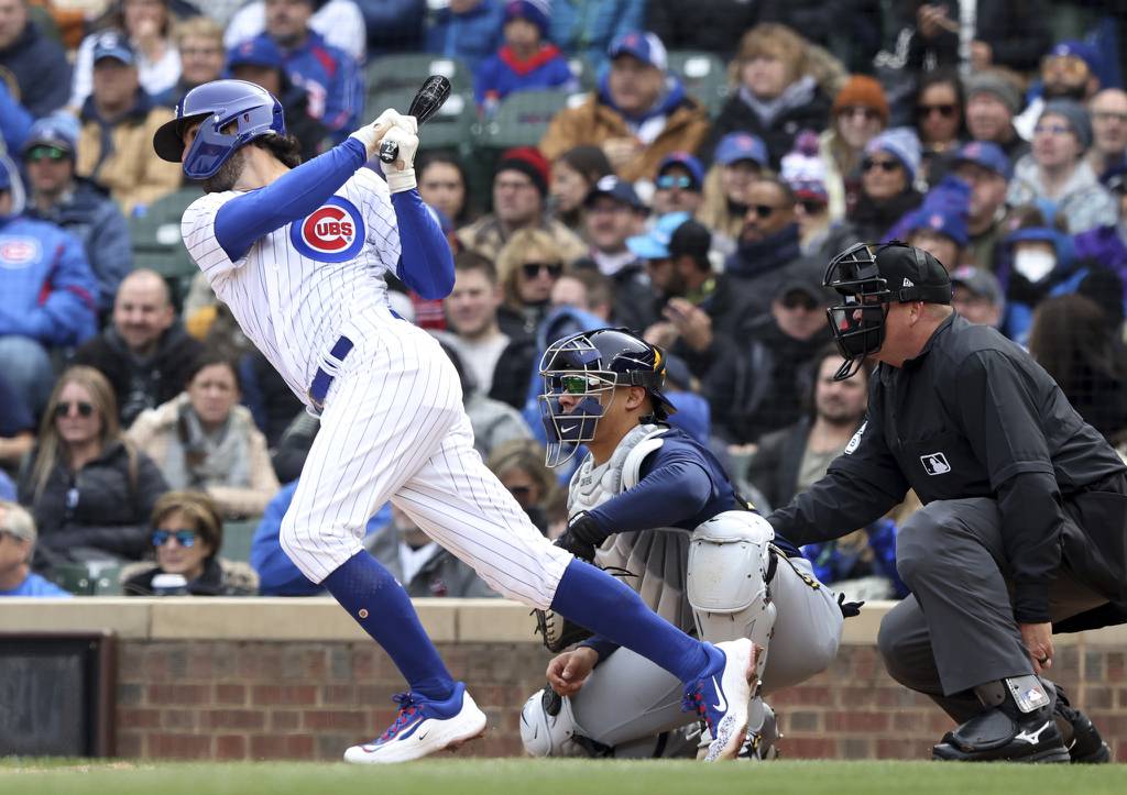 Chicago Cubs shortstop Dansby Swanson (7) swings through for a two-run single against the Milwaukee Brewers in the third inning on opening day at Wrigley Field Thursday, March 30, 2023, in Chicago. (John J. Kim/Chicago Tribune)