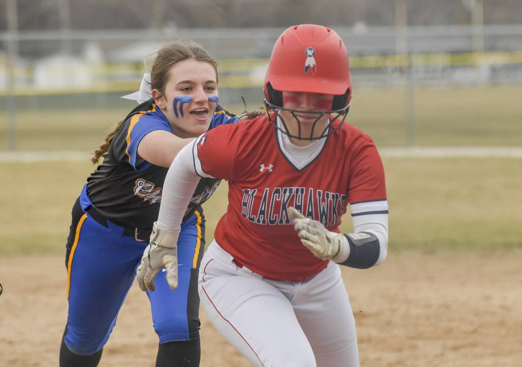 Aurora Central Catholic's Kate Gambro, left, tags out West Aurora's Mackenzie Fraus during a rundown in the sixth inning of a nonconference game on Monday, March 20, 2023.