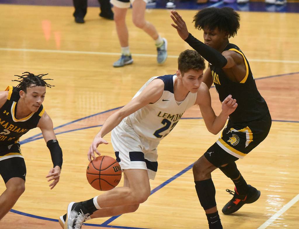 Lemont's David Bilevicius (23) drives the lane against Marian Catholic's Quentin Jones (1) during a Class 3A Hillcrest Sectional semifinal in Country Club Hills on Wednesday, March 1, 2023.