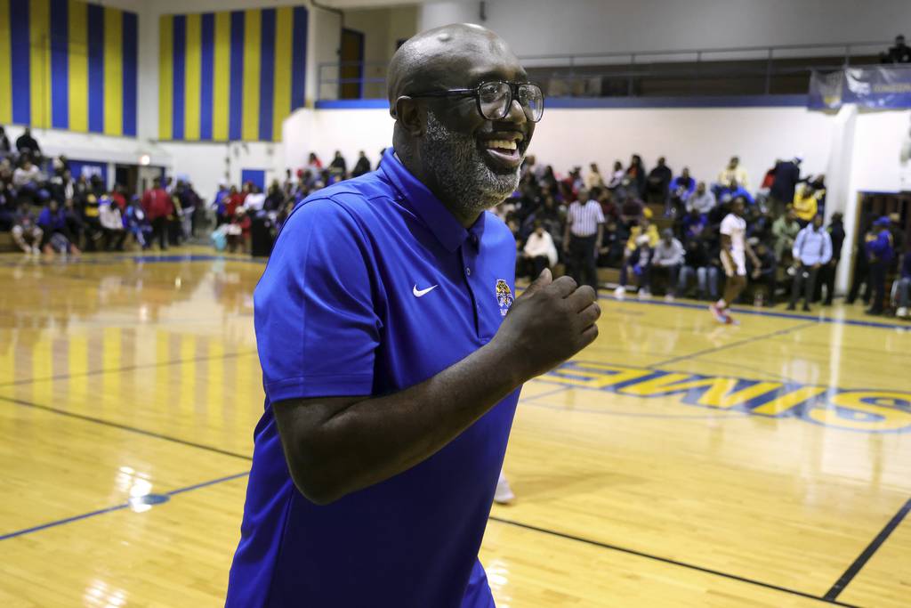 Simeon Career Academy basketball coach Robert Smith celebrates at Simeon in Chicago on Jan. 24, 2023, after getting his 500th career win.