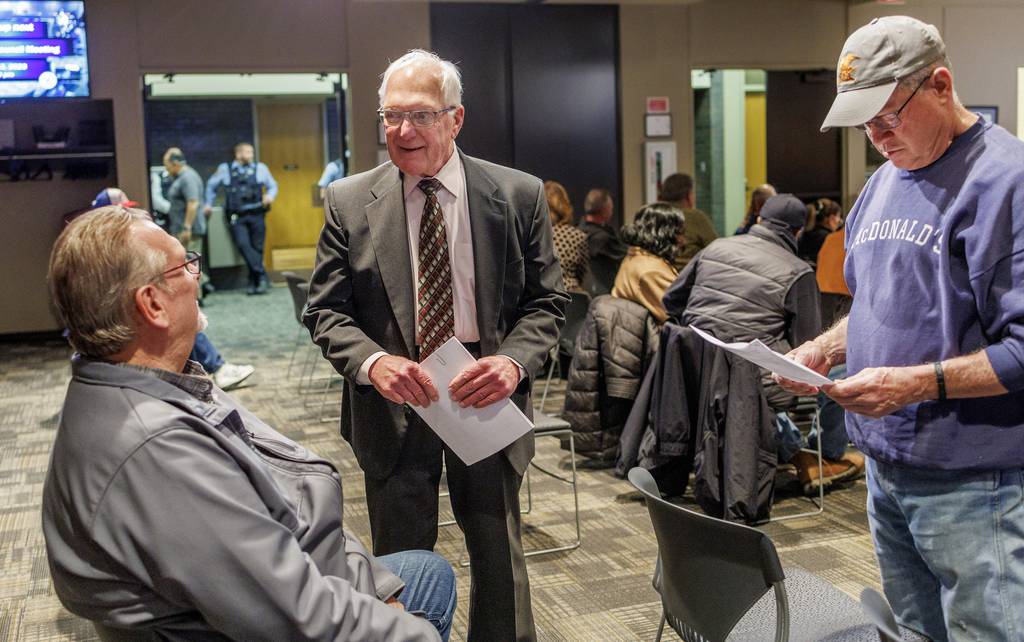 Joliet City Council member Patrick Mudron, center, talks with attendees before a meeting at Joliet City Hall, March 13, 2023.