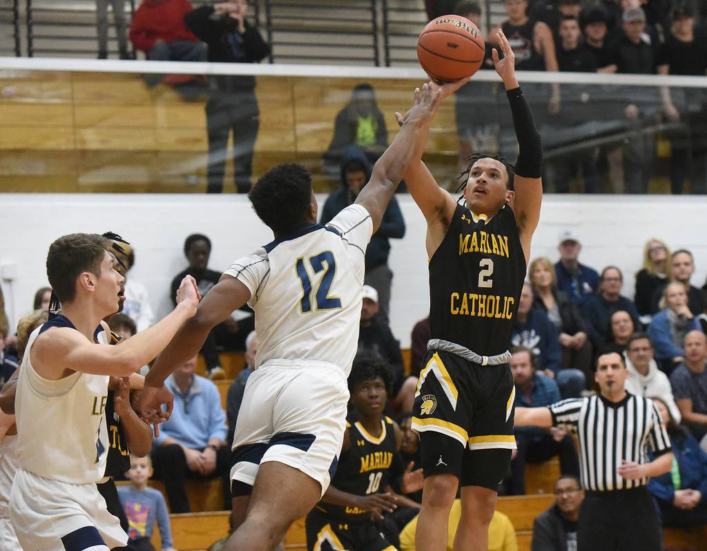 Marian Catholic's Tre Davis (2) attempts a shot over Lemont's Miles Beachum (12) during a Class 3A Hillcrest Sectional semifinal in Country Club Hills on Wednesday, March 1, 2023.