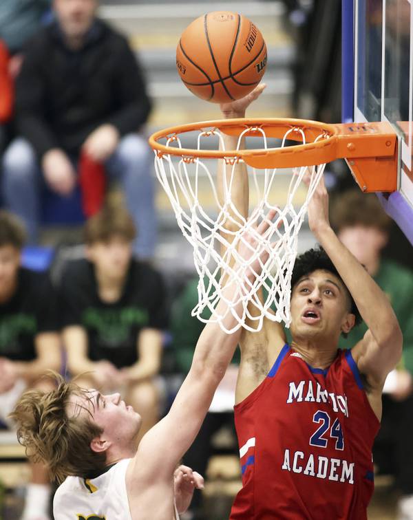 Marmion's Trevon Roots (24) converts a basket against Crystal Lake South's Brady Schroeder (5) during a Class 3A Burlington Central Sectional semifinal game on Tuesday, Feb. 28, 2023.