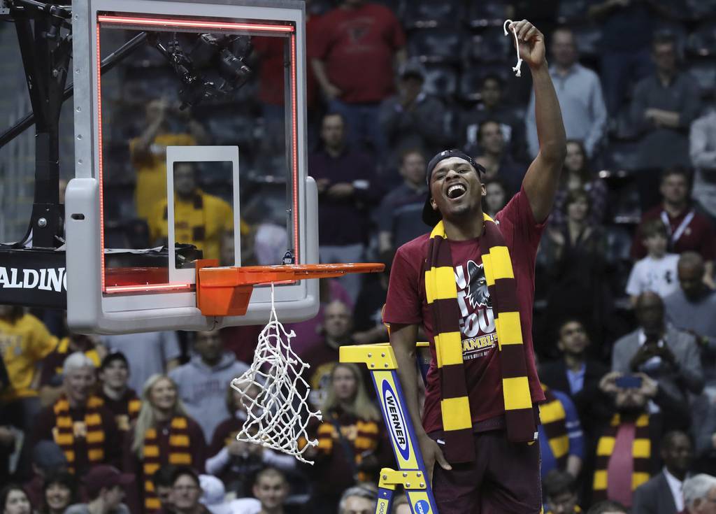 Loyola Ramblers guard Donte Ingram cuts down a piece of the net after beating the Kansas State Wildcats 78-62 in the Elite 8 game of the NCAA tournament at Philips Arena, March 24, 2018, in Atlanta. 