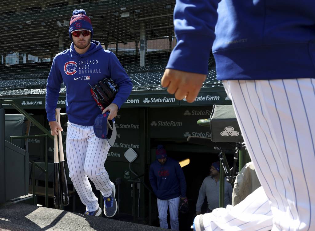 Cubs left fielder Ian Happ walks out of the dugout for a practice Wednesday at Wrigley Field. 