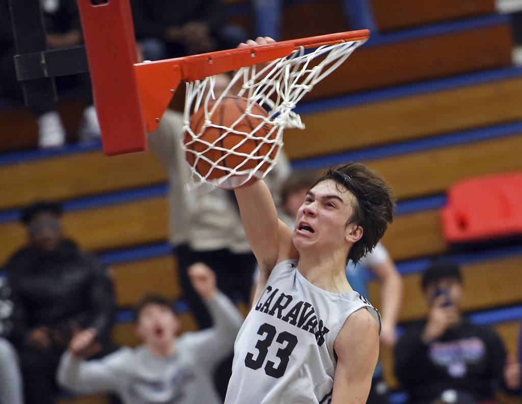 Mount Carmel's Angelo Ciaravino (33) dunks the ball against Hyde Park during a Class 3A Glenbard South Sectional semifinal game in Glen Ellyn on Wednesday, March 1, 2023.