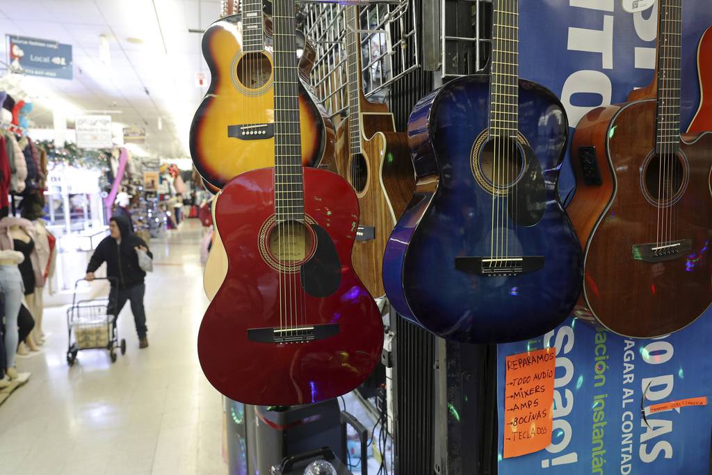 Guitars for sale hang on racks at Ceasar's Music of Illinois inside Little Village Discount Mall on Jan. 5, 2023.