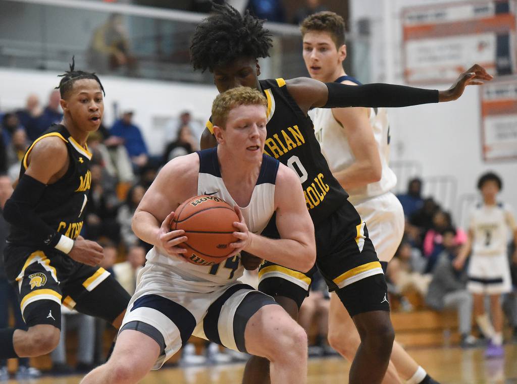 Lemont's Conor Murray (14) works up the court against Marian Catholic's Jonah Weathers (10) during a Class 3A Hillcrest Sectional semifinal in Country Club Hills on Wednesday, March 1, 2023.