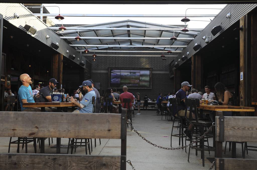 Cubs fans watch the game at Old Crow's open roof bar on Clark Street during the Cubs season opener against the Brewers on July 24, 2020.  