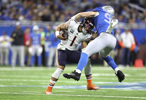 Lions defensive end Aidan Hutchinson tackles Bears quarterback Justin Fields on Jan. 1, 2023, in Detroit.