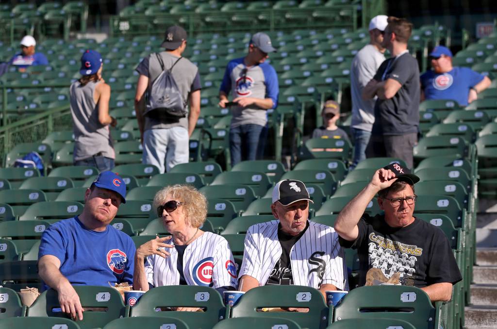 Cubs and Sox fans take in batting practice before a game between the two teams at Wrigley Field in Chicago on June 18, 2019. 