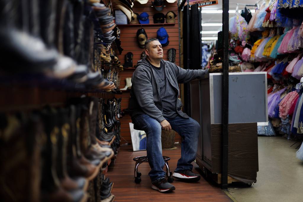 Eduardo Oliva, 48, sits for a portrait in his store at the Little Village Discount Mall on Feb. 15, 2023, in Chicago. Oliva’s booth is on the side of the Discount Mall that will remain open.