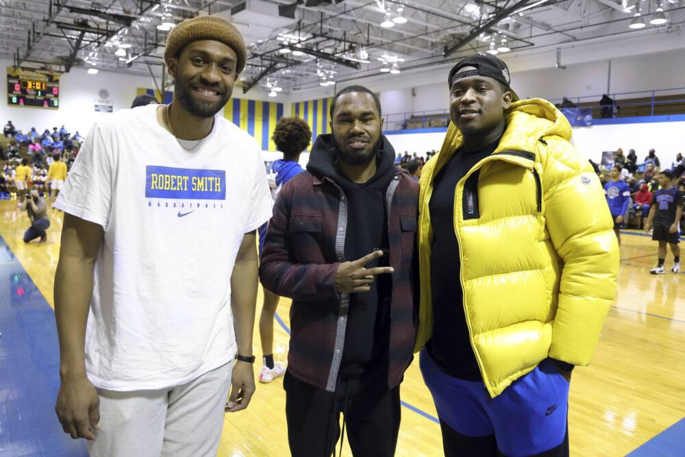 Former Simeon Career Academy basketball stars Jabari Parker, from left, Jaylon Tate and Kendall Pollard attend a game in Chicago as Simeon faces Gwendolyn Brooks College Preparatory Academy at Simeon on Jan. 24, 2023. Simeon head coach Robert Smith achieved his 500th career win at the game.