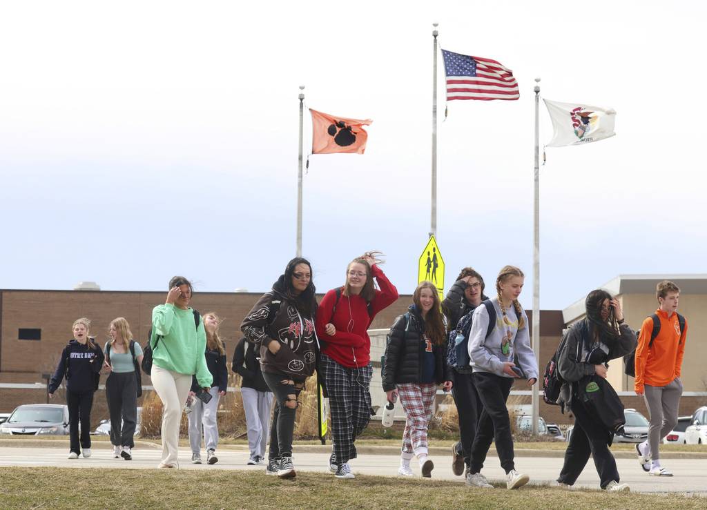 Wheaton Warrenville South High School students leave school on March 20, 2023, in Wheaton. 