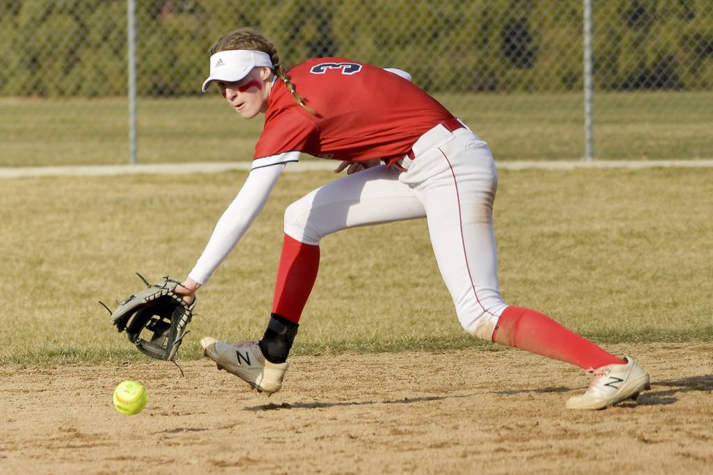 West Aurora shortstop Sara Tarr (3) ranges far to her right to backhand a ground ball against Aurora Central Catholic hitter during a nonconference game on Monday, March 20, 2023.