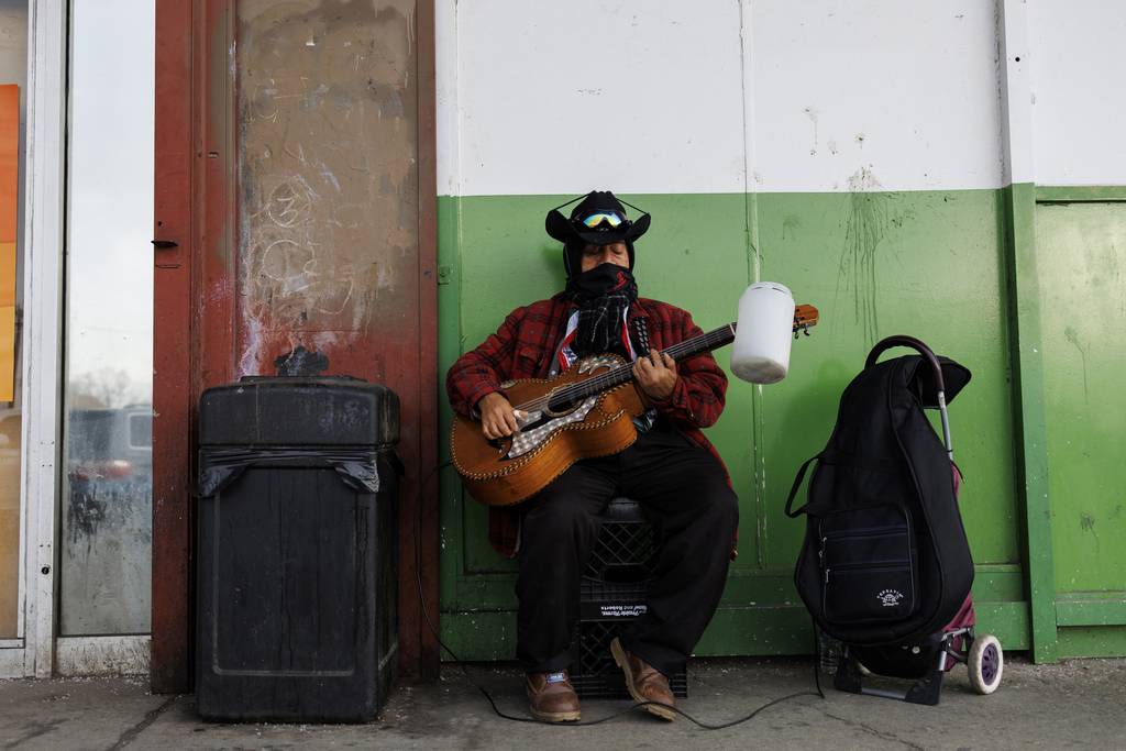 Martin Santiago, 64, plays guitar outside the Little Village Discount Mall on Feb. 14, 2023, in Chicago. 