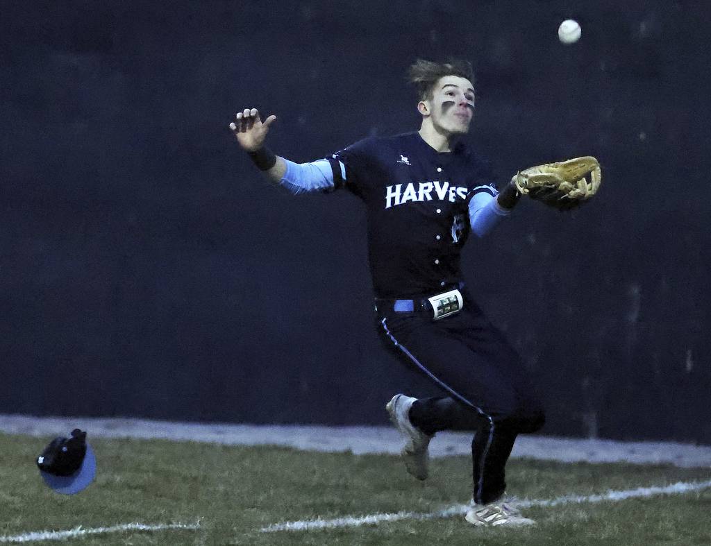 Harvest Christian's Stephen Combs (17) races to catch a foul ball against Kaneland during a nonconference game at Judson's Hoffer Field in Elgin on Tuesday, March 21, 2023.
