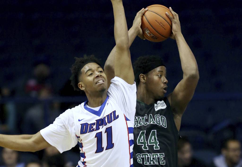 Chicago State center Quron Davis, right, looks to pass as DePaul guard Eli Cain defends at Allstate Arena, Dec. 5, 2015, in Rosemont.