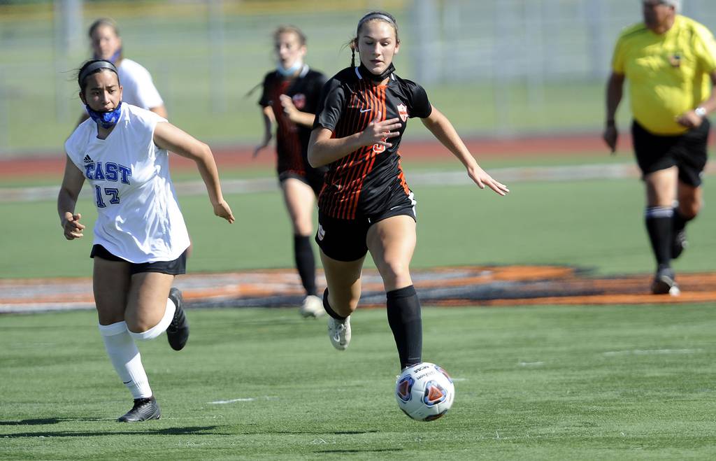 Lincoln-Way West's Nora Gaffney (3) races up the field against Lincoln-Way East's Bianca Cahue (17) before scoring a goal during a Class 3A regional final in New Lenox on Friday, June 4, 2021.