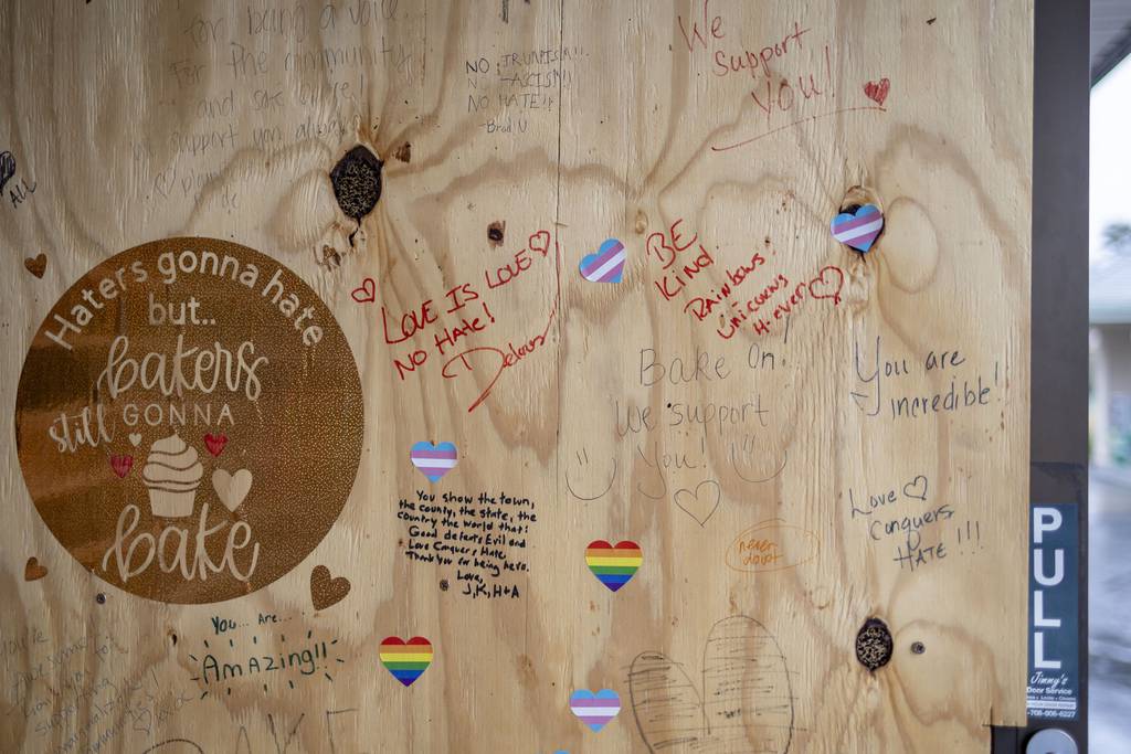 Notes are left on the door that was previously vandalized as diners arrive for a drag brunch performance at UpRising Bakery and Cafe on Aug. 7, 2022, in Lake in the Hills. 