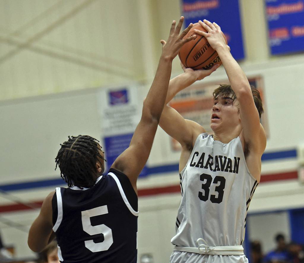 Mount Carmel's Angelo Ciaravino (33) shoots over Hyde Park's Jurrell Baldwin during a Class 3A Glenbard South Sectional semifinal game in Glen Ellyn on Wednesday, March 1, 2023.