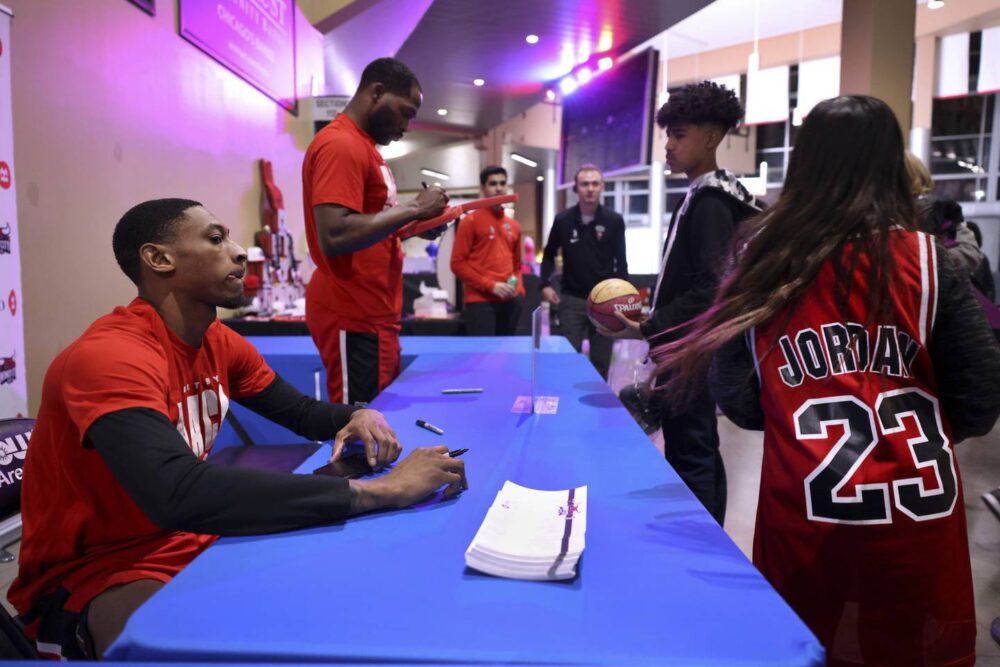 Windy City Bulls forward Ben Coupet signs autographs for fans after a game against the Raptors 905 at Now Arena in Hoffman Estates on Feb. 22, 2023. 