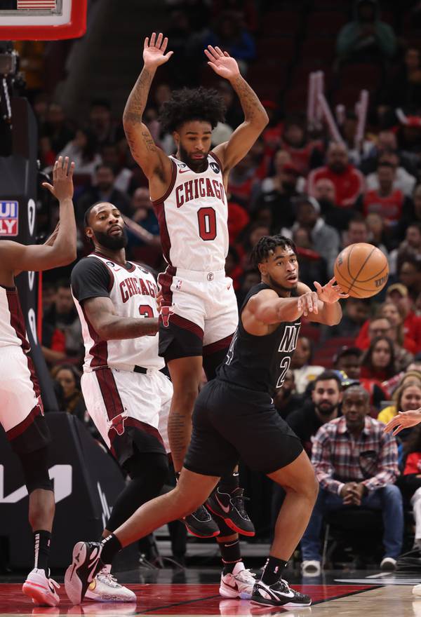 Bulls guard Coby White (0) leaps while defending Nets guard Cam Thomas on Feb. 24 at the United Center. 