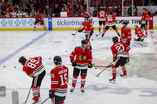 Blackhawks players skate on the ice during warmups before playing the Canucks at the United Center on March 26, 2023.