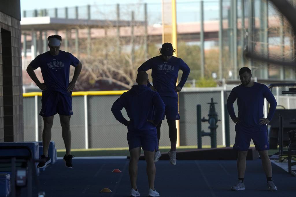 Cubs players warm up during a spring training workout on Feb. 15, 2023.