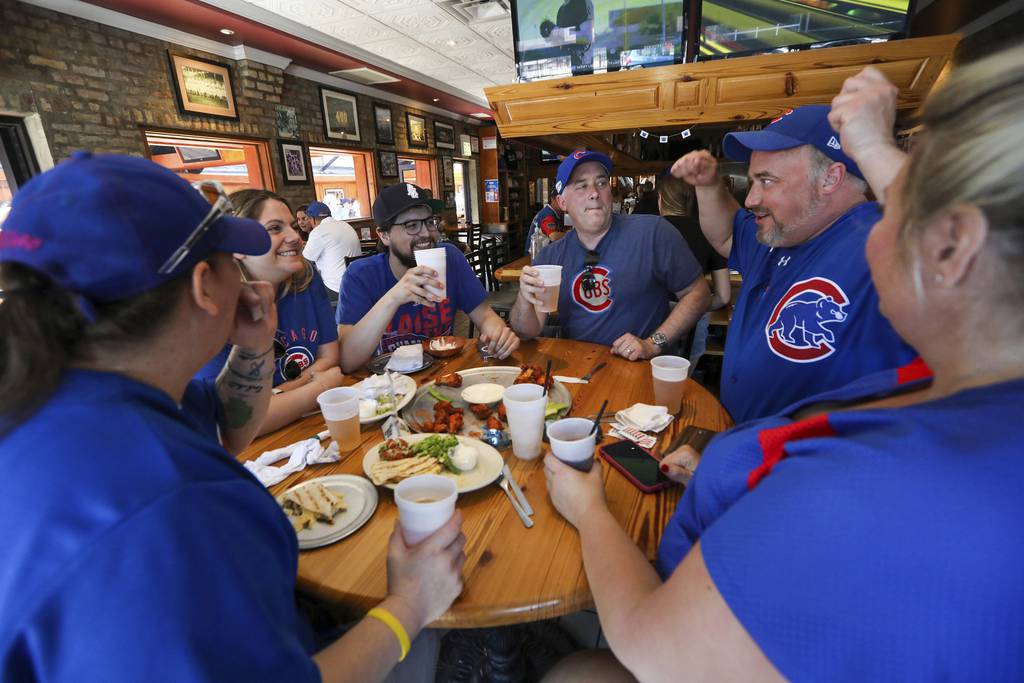 Gary Willis, right, of Lake Forest, gestures to his family and friends as they gather at Yak-Zies Bar and Grill located near Wrigley Field in Chicago on June 11, 2021. 