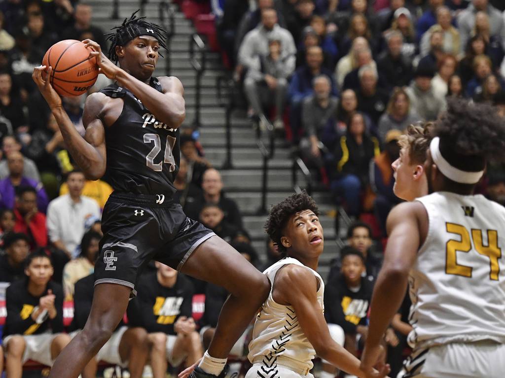 Oswego East's Mekhi Lowery (24) comes down with a rebound against Joliet West during the Class 4A Bolingbrook Sectional championship game on Friday, March 3, 2023.