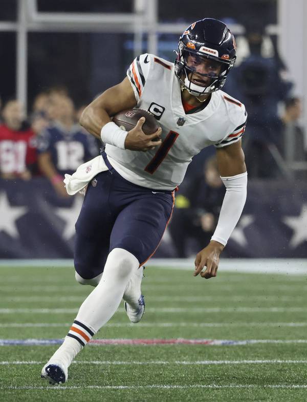 Bears quarterback Justin Fields keeps the ball for a first down against the Patriots on Oct. 24, 2022, in Foxborough, Mass.