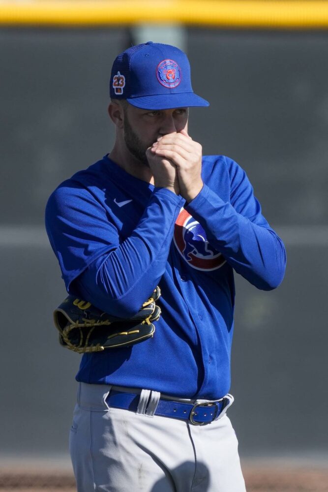 Brad Boxberger tries to warm his hands during a Cubs spring training workout on Feb. 15, 2023.