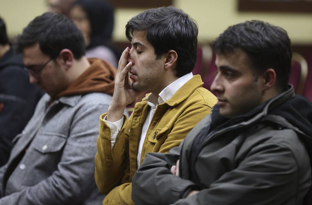 Mehmet Deniz, center, attends a vigil for the victims of the earthquake in Turkey and Syria at the Turkish American Society of Chicago in Mount Prospect on Feb. 9, 2023.  