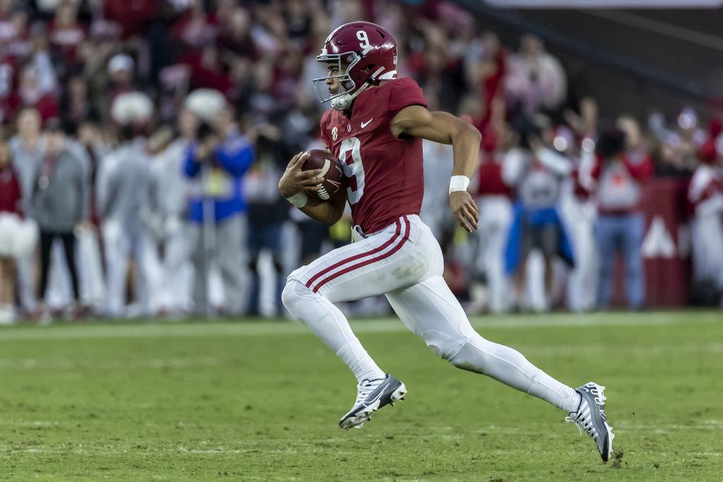 Alabama quarterback Bryce Young runs the ball for a long gain during the first half of a game against Auburn on Nov. 26, 2022.