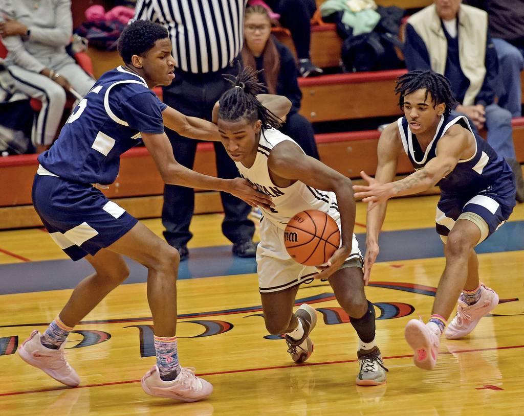 Mount Carmel's DeAndre Craig drives through traffic against Hyde Park during a Class 3A Glenbard South Sectional semifinal game in Glen Ellyn on Wednesday, March 1, 2023.