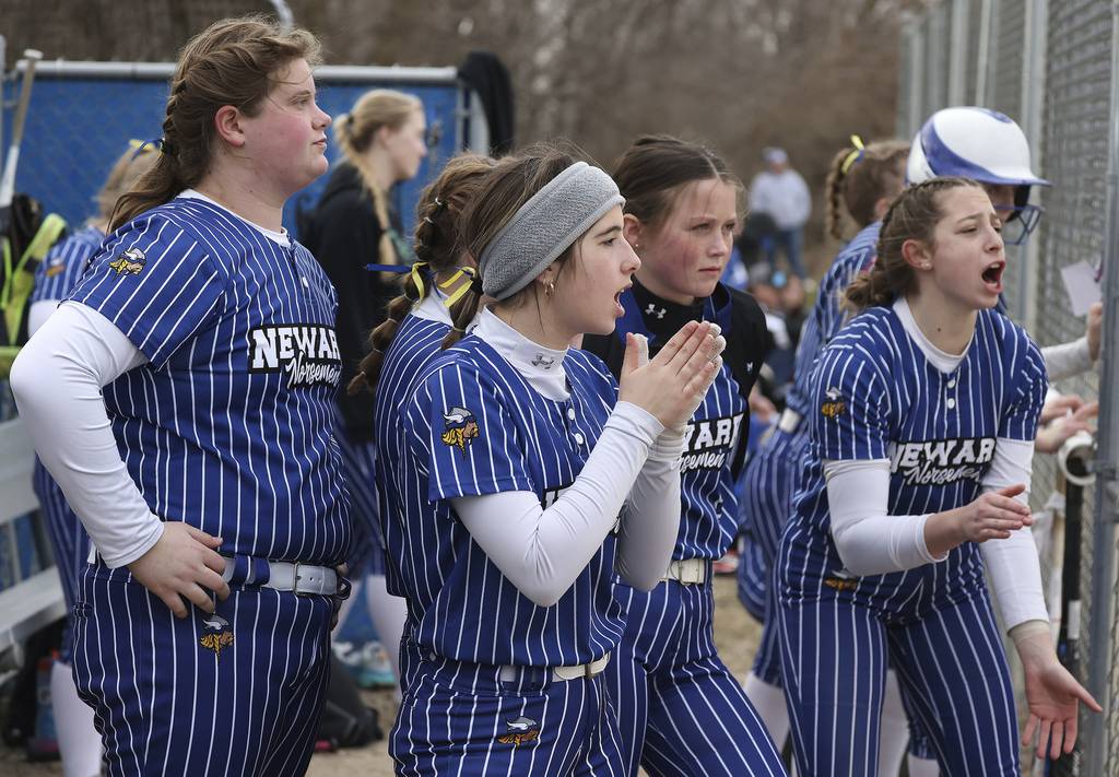 Newark players Kate Bromeland (19), Peyton Wohead (15), Cali Beyer (6) and Kodi Rizzo (20) cheer from the dugout against Rosary during a nonconference game on Thursday, March 30, 2023.