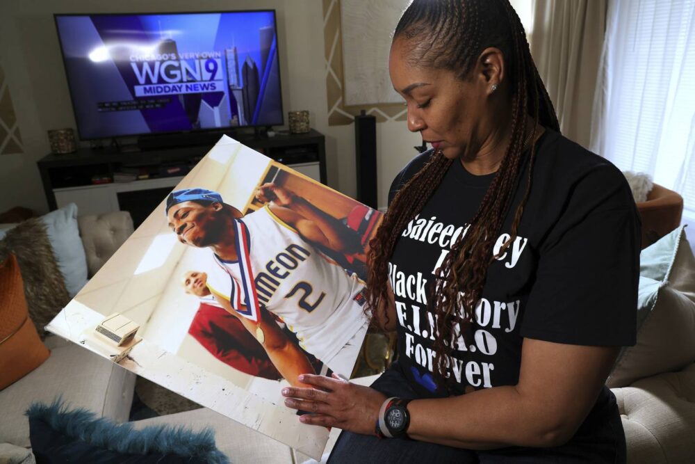 Chareda Carter, the mother of slain Simeon basketball player Saieed Ivey, at home in Glenwood with a photo of Ivey on Feb. 15, 2023. Ivey played on the 2013 Simeon team and had moved to California to play basketball at East Los Angeles College when he was shot and killed in 2016.