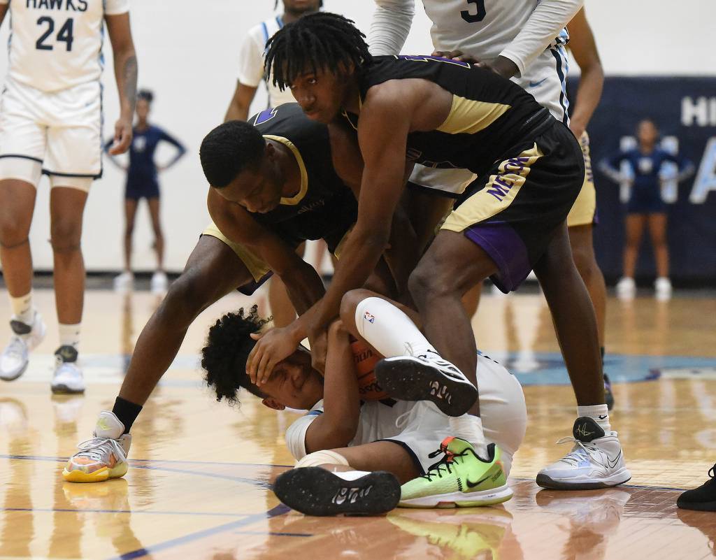 Hillcrest's JayQuan Ratliff (10) hits the floor and holds the ball against T.F. North during the Class 3A Hillcrest Sectional semifinals in Country Club Hills on Tuesday, Feb. 28, 2023.