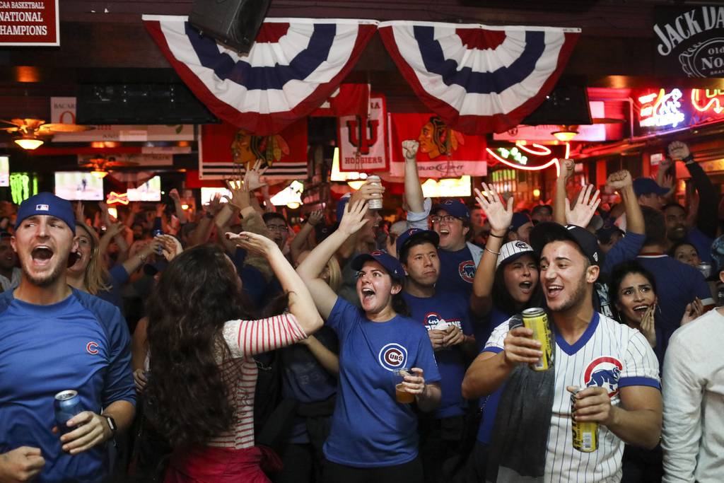 Fans cheer inside Sluggers World Class Sports Bar during Game 7 in the World Series on Nov. 2, 2016, in Chicago.