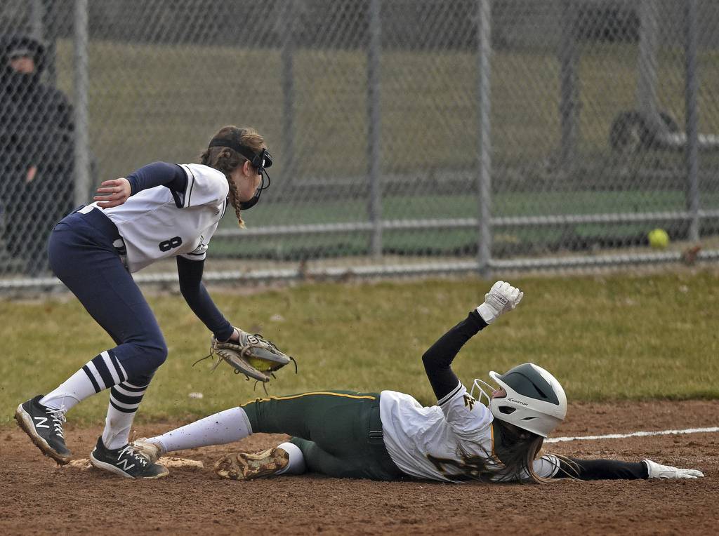 Waubonsie Valley's Gia Cobert gets tagged out at third base by West Chicago's Sophia Ptak, left, during a nonconference game in Aurora on Thursday, March 23, 2023.