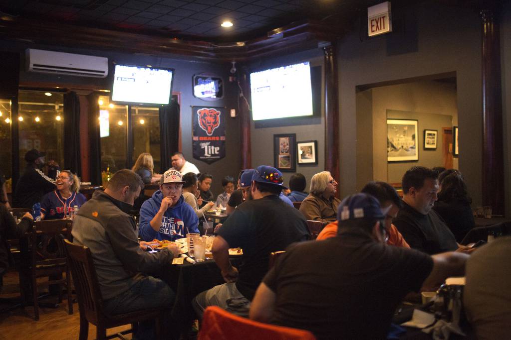 Patrons watch the Cubs play the Mets in Game 2 of the National League Championship Series at Output Lounge on Oct. 18, 2015, in Chicago.