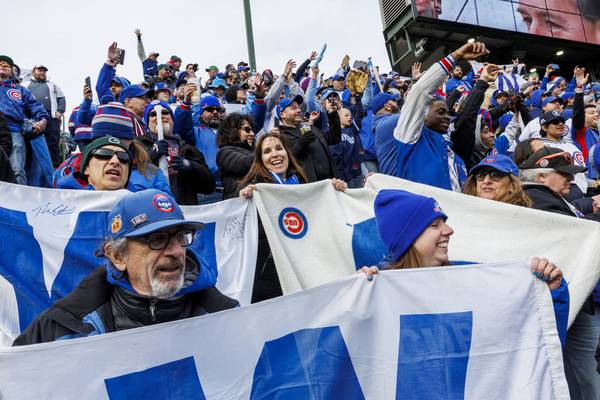 Fans in the bleachers celebrate after the Cubs defeated the Brewers 4-0 at Wrigley Field on March 30, 2023.