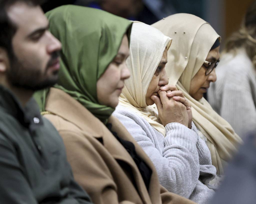People pray for the victims of the earthquake in Turkey and Syria during a vigil at the Turkish American Society of Chicago in Mount Prospect on Feb. 9, 2023.  