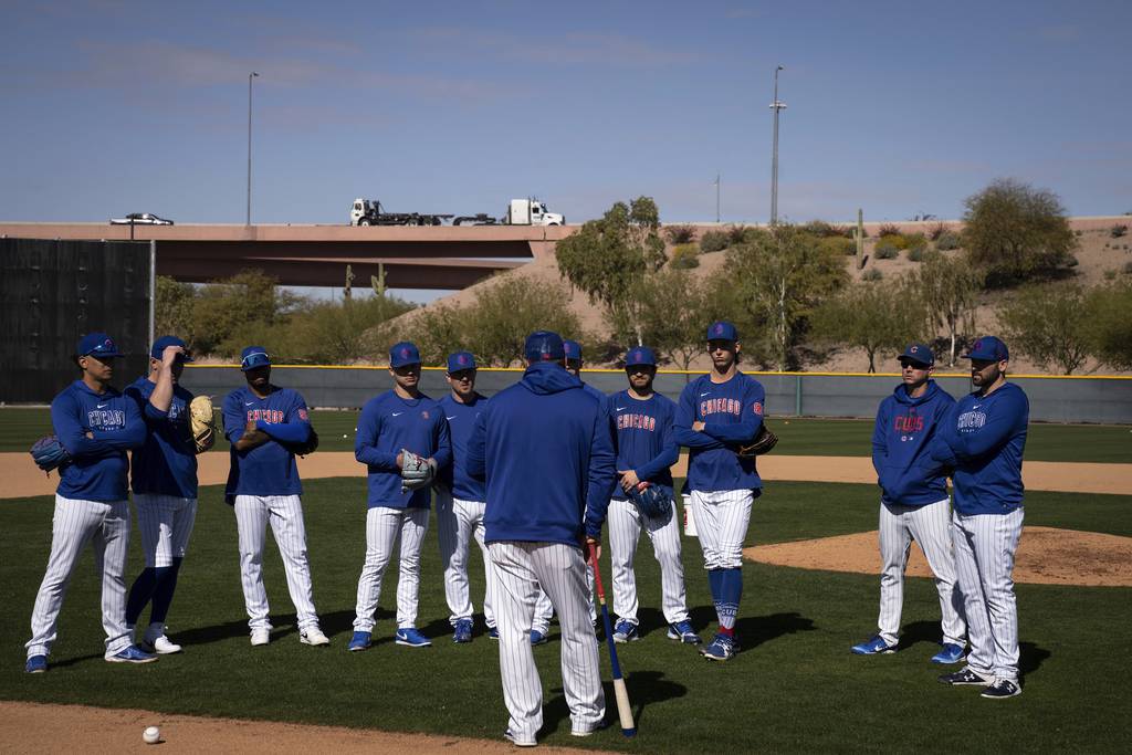 Cubs pitchers receive instruction before fielding drills during workouts at Sloan Park on Feb. 23, 2023, in Mesa, Ariz. 
